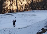 Fore! Golfer tees off in the snow at George Wright today