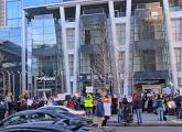 People protesting Musk outside the Prudential Center Tesla showroom