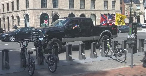 Guy flying confederate fla near Massachusetts State House