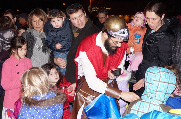 Judah Maccabbee hands out dreidels in Brookline