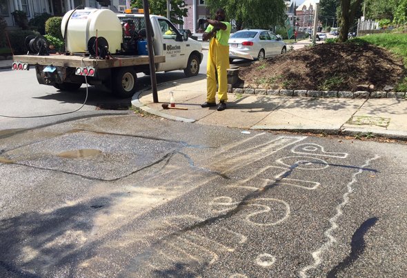 Power washing guerilla crosswalk in Roslindale