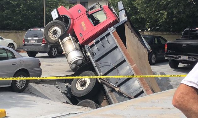 Dump truck falls through Quincy garage