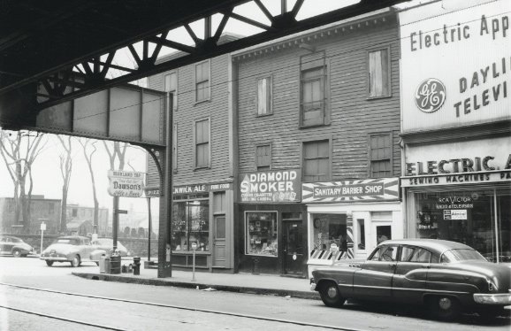 Street scene under an el in old Boston