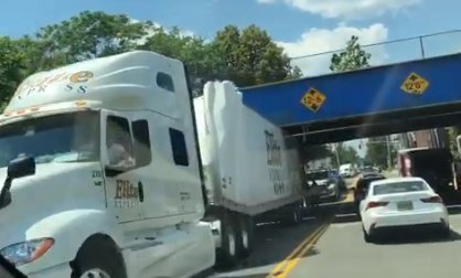 Truck wedged under an Orange Street bridge in Malden