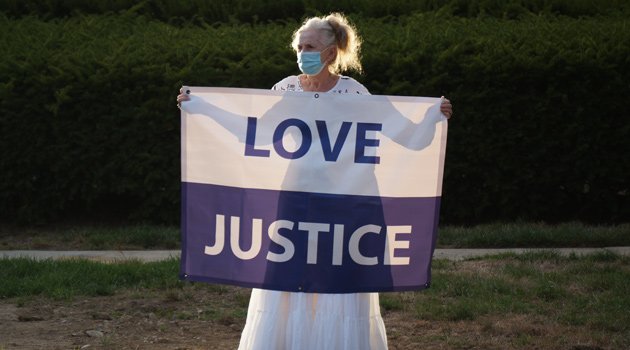 Woman with Love and Justice banner