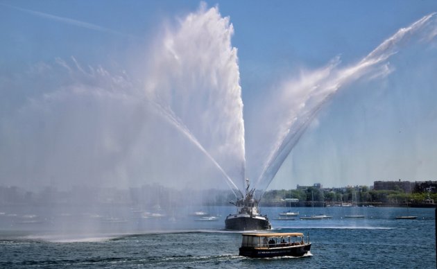 Old fireboat spraying water in Boston Harbor