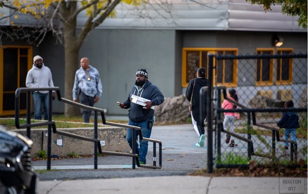 Detective leaving Holland School with evidence