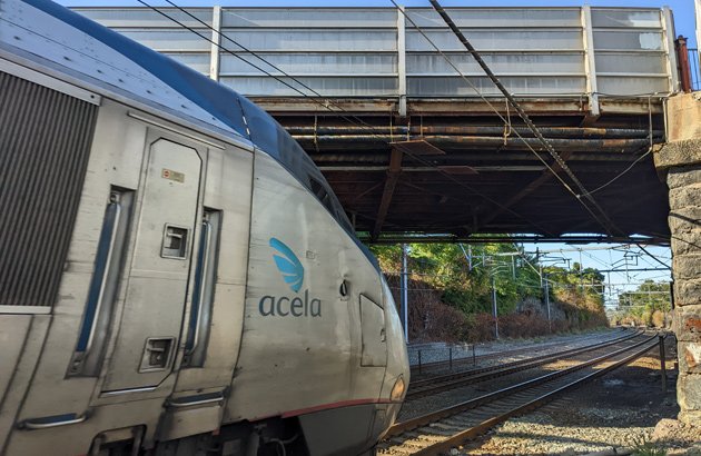 Acela train about to go under bridge