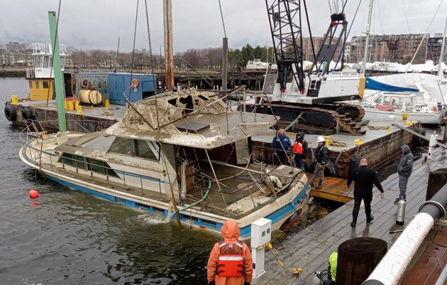 Sunk boat is raised up in Boston Harbor