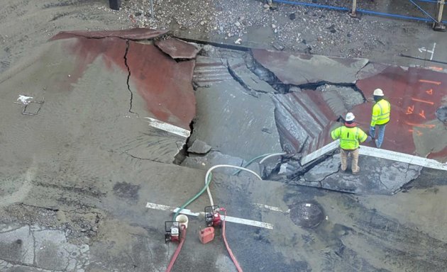 Big hole in the ground where the water main burst