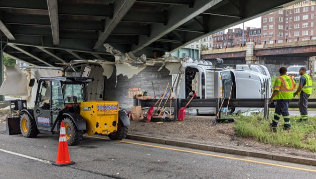 Crew tries to remove storrowed truck at Bowker Overpass