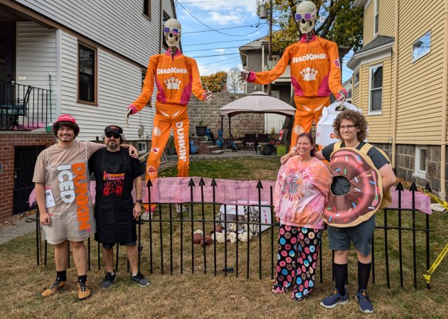 The DeMasi-Marx family on Tyndale Street with Home Depot giant skeletons dressed as DeathKings