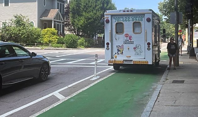 Ice-cream truck parked in a bike lane
