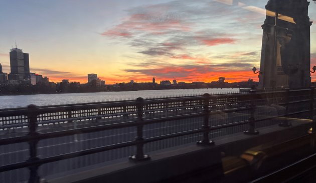 View of the sunset from a Red Line train crossing the Longfellow Bridge into Cambridge