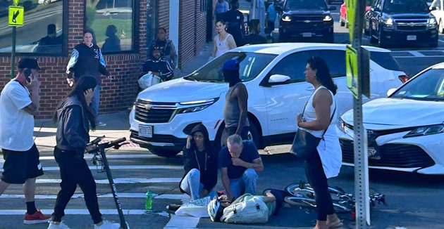 Bystanders attend to downed bicyclist before police, paramedics arrive