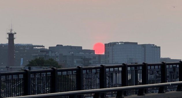 Hazy red sunrise over Boston