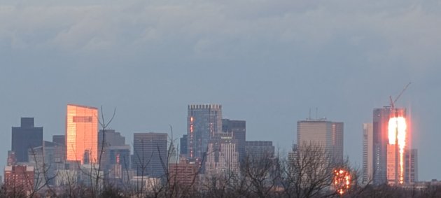 Two downtown building fiercely reflecting the setting sun around 4:05 p.m.