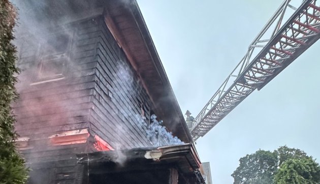 Firefighter, ladder at smoky house on Tip Top Street