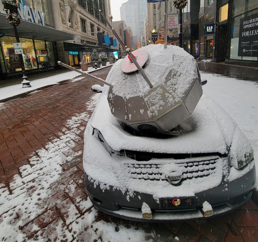 Satellite and smashed car on Washington Street downtown in the snow