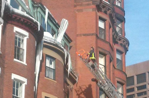 Firefighter takes on a giant icicle on Beacon Hill