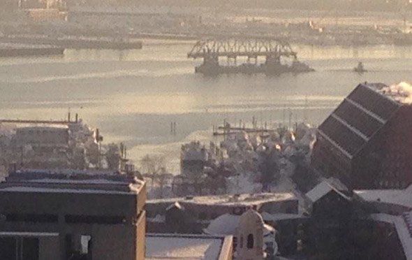 Part of the Long Island bridge floats through Boston Harbor