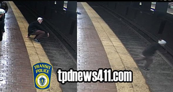 Guy walking across tracks at Andrew station in South Boston