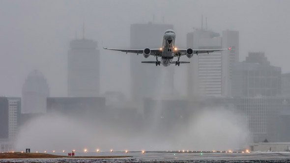 Plane taking off at Logan Airport