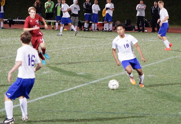 Roger Cawdette sets up for Boston Latin School in soccer match.