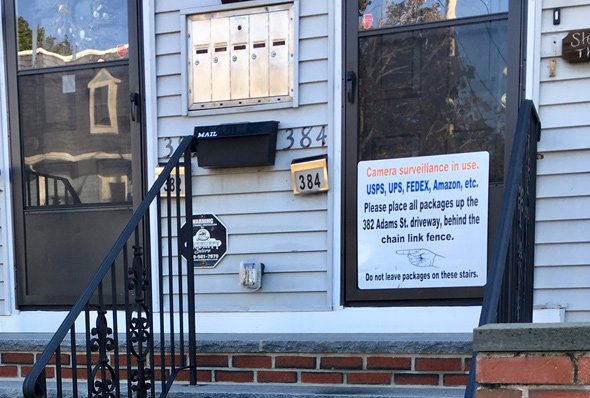 Sign alerting delivery people to put packages around the corner