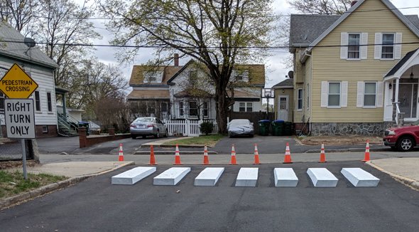 Apparent concrete blocks at exit of Brooks School parking lot