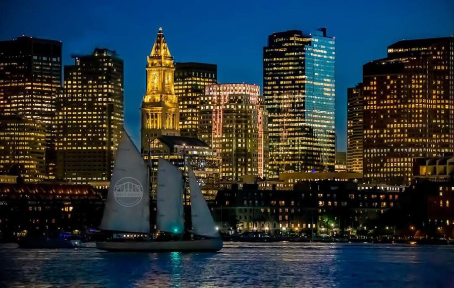 Sloop passes in front of downtown Boston