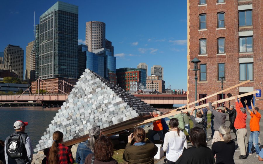 Pyramid sculpture being launched into Fort Point Channel in Boston