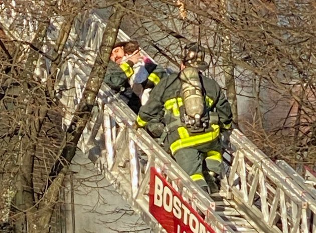 Firefighters from Ladder 4 rescue child at West Newton Street fire.