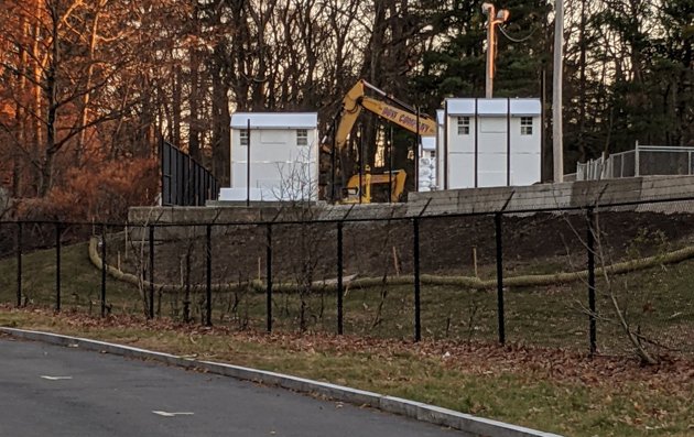 Temporary shelters under construction at Shattuck Hospital