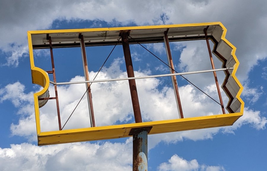 Clouds through a former Blockbuster sign in Roslindale