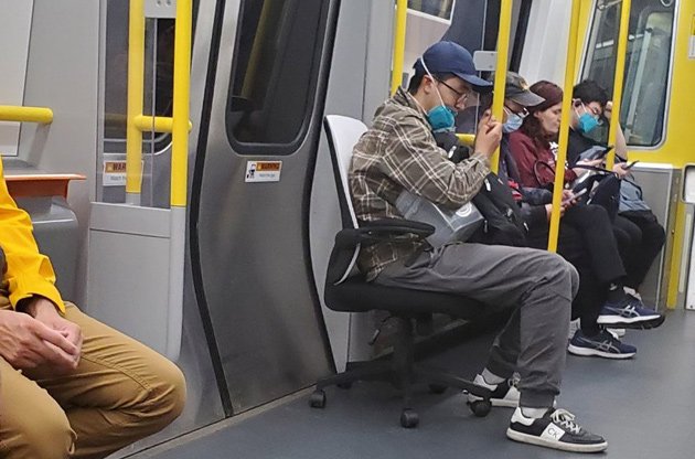 Guy in a chair on the Orange Line