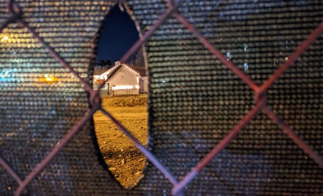 Hole in fence at dirt dump