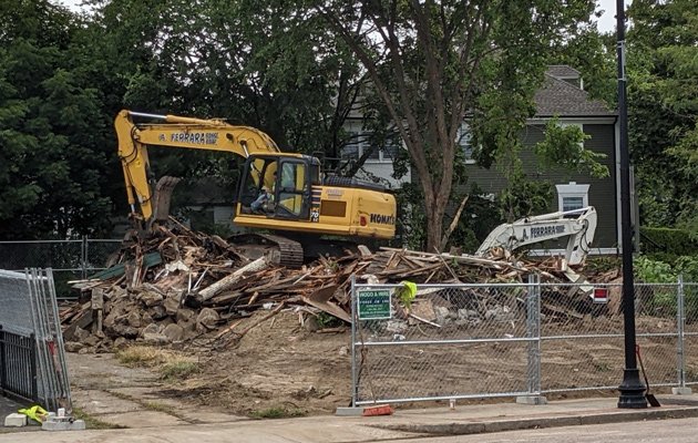 What's left of 19th century house on Centre Street, with backhoe on top