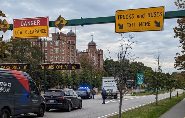 Truck doing the backup of shame on Memorial Drive under signs telling truck drivers to exit