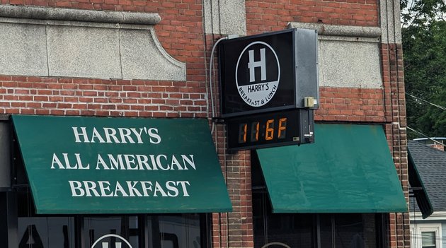 Digital thermometer reading 116 degrees on Centre Street in West Roxbury