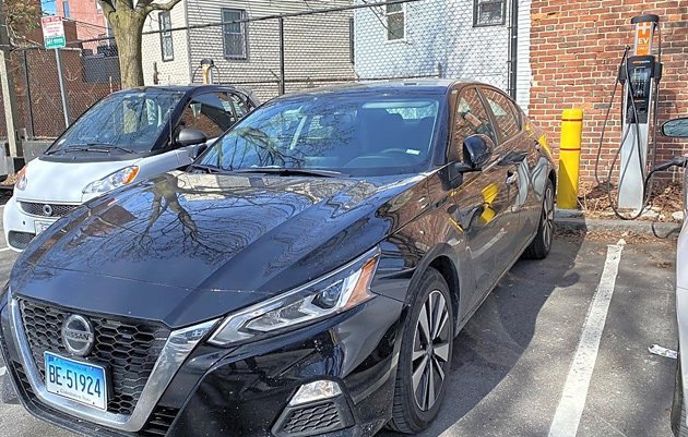 Stupid Nissan parked in space reserved for an EV