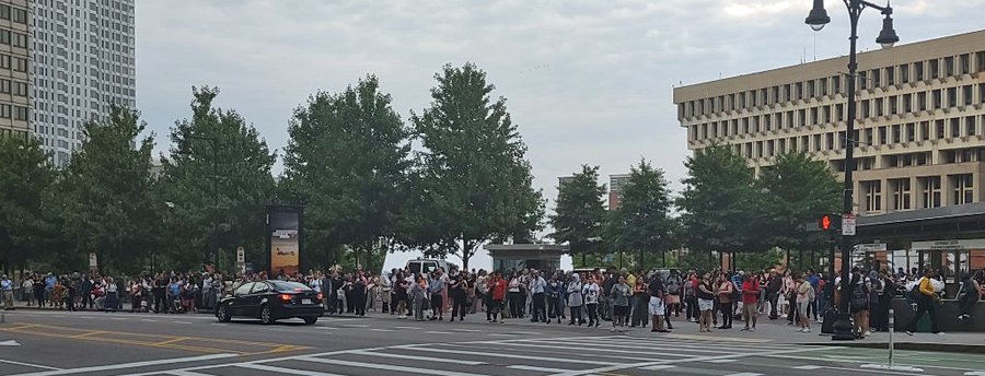 A line of blue people waiting for the Blue Line