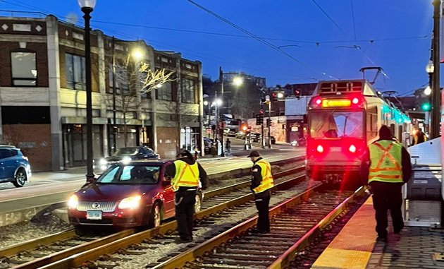 Car on the E Line tracks at Brigham Circle