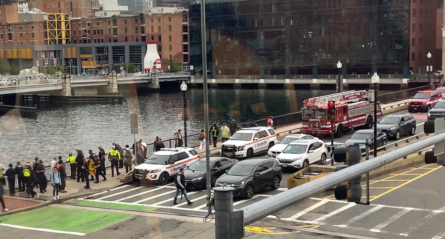 First responders and onlookers gather along Fort Point Channel