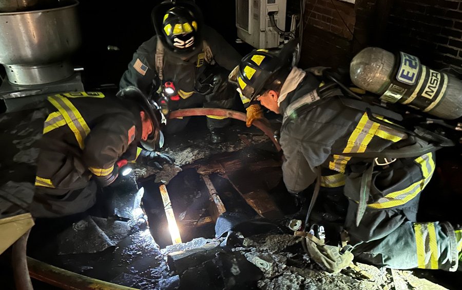 Firefighters on roof checking to make sure the fire hasn't spread