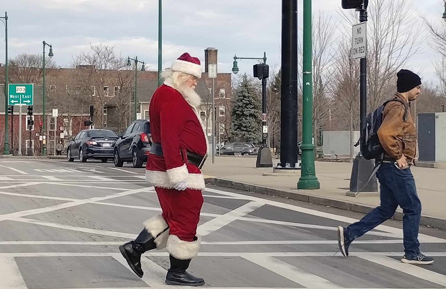 Santa crossing Washington Street to the Forest Hills T station