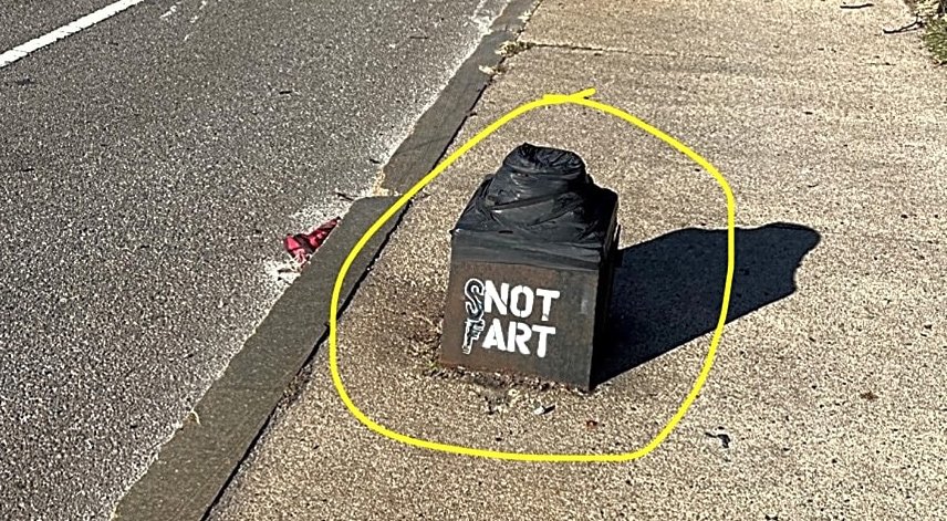 Remains of a light pole with modified NOT ART stencil