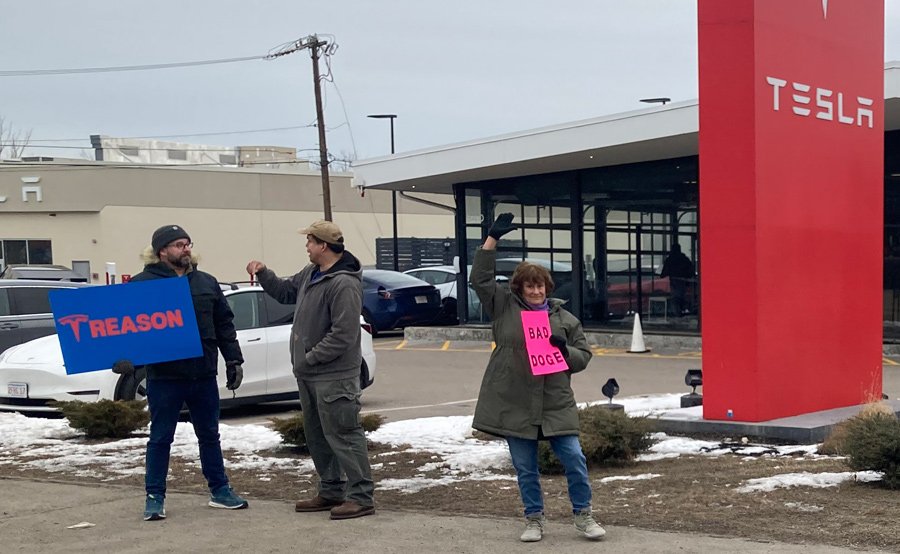 Anti-Musk protesters outside Tesla showroom in Dedham