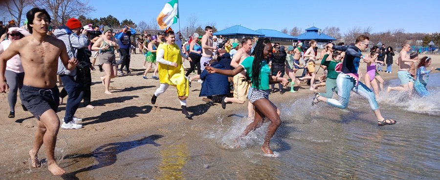 People running into the water at Constitution Beach