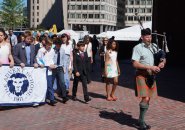 Bagpiper and Advent School sixth graders